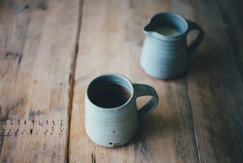 Mug of tea and milk pitcher