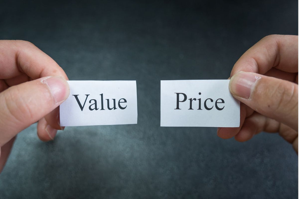 Two pieces of paper next to each other. One reads Value and the other reads Price.