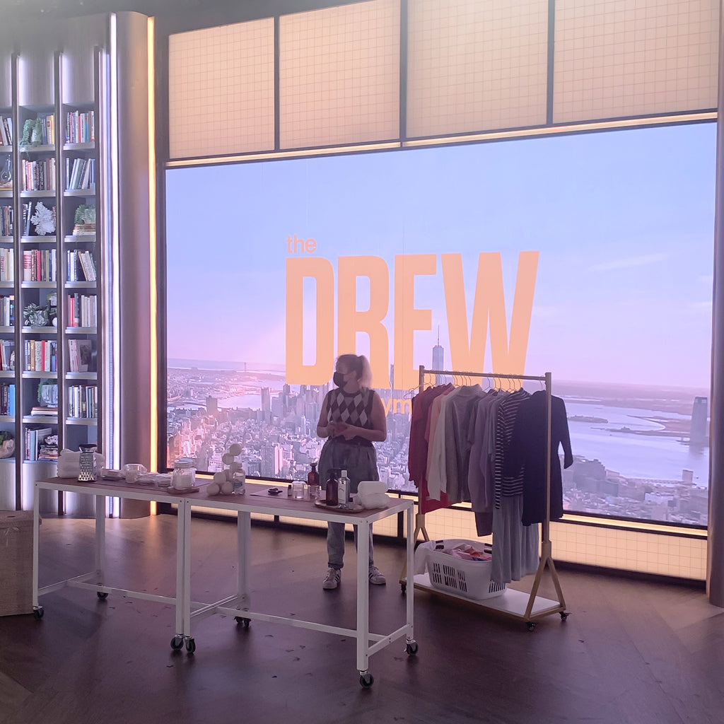 A staff member preparing the set for Celsious' segment on The Drew Barrymore Show