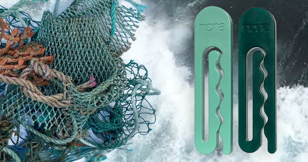 A pile of green fishing nets is displayed next to two recycled ocean plastic clothespins by NONA