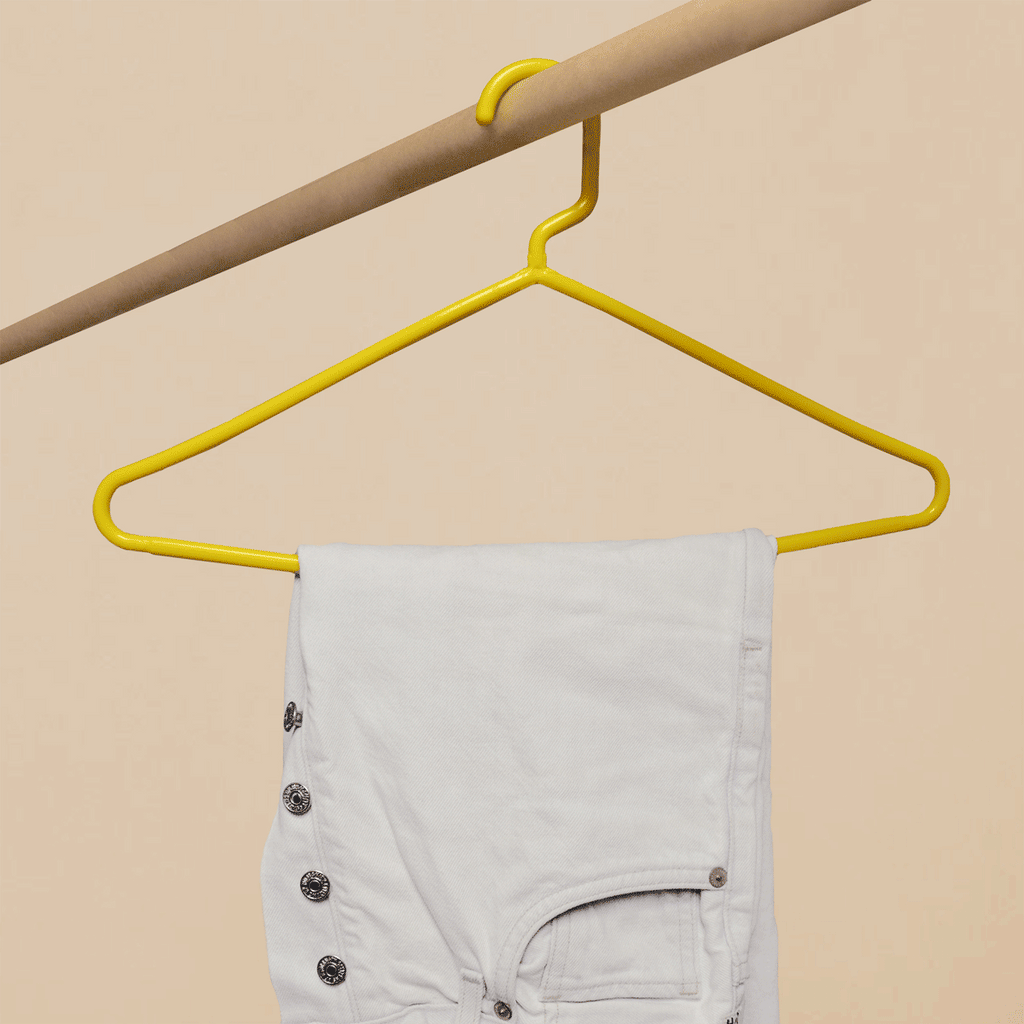 A gif of a weak yellow hanger buckling under the weight of jeans and a strong hanger