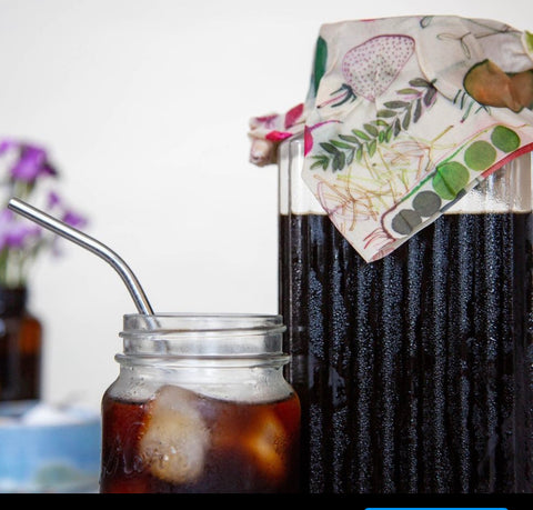 Iced coffee in glass pitched covered with Z Wraps reusable food wrap