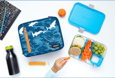 a lunch spread with a Packit lunchbox featuring a shark print