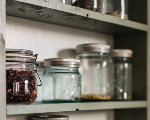pantry shelves with mason jars storing different ingredients