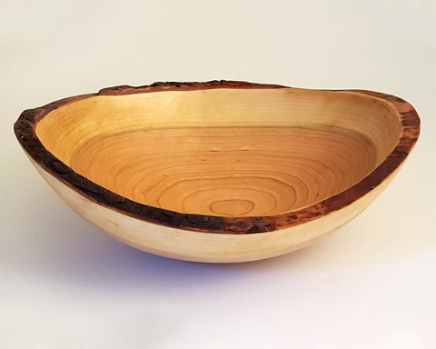 A 10" oval bowl turned from upcycled Cherry wood by Spencer Peterman