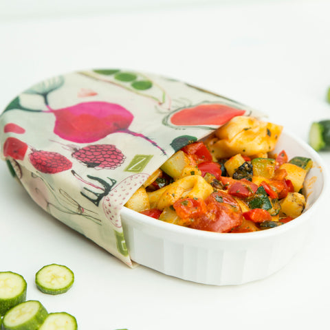a yummy casserole with tortellinis and veggies in a white corningware dish, covered with the farmhouse pattern Z Wrap