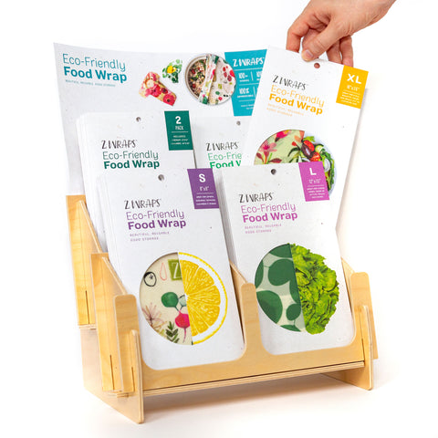 a wooden counter display of z wraps, with a hand choosing one