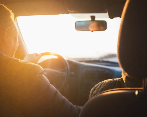 people driving a car in a golden light