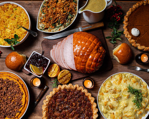 A holiday meal table full of special foods and desserts.