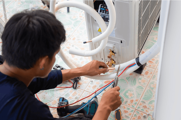 Technician installing a condensate pump