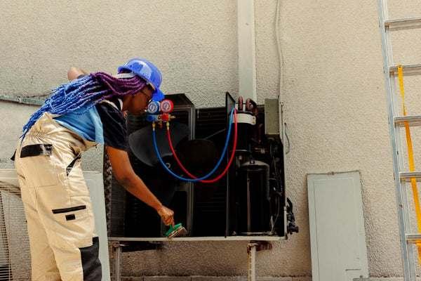 Technician conducting heat pump maintenance