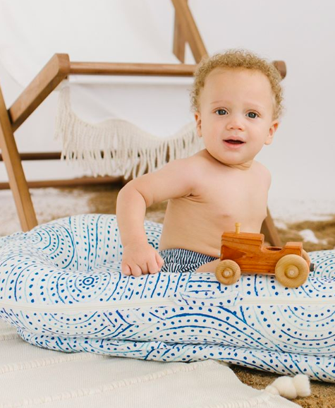 child sitting in DockATot