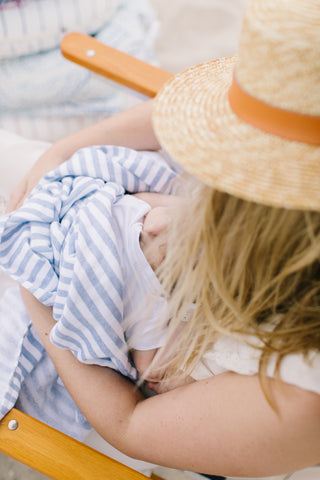 Mother holding baby at the beach