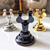 Mr. P's simple place card holders in silver, black lacquer and gold finishes