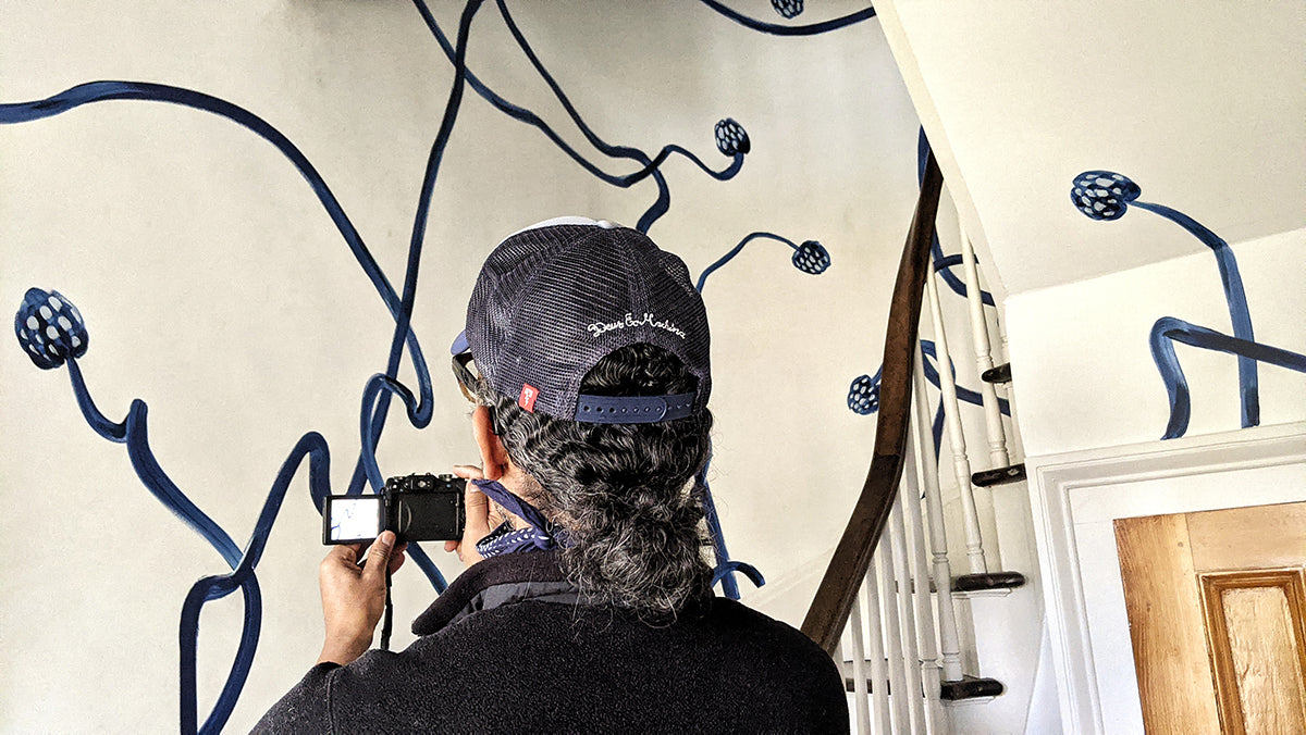 Co-founder Martin Cooper takes images of the hand painted mural in Oliver's stairwell