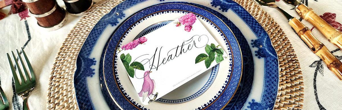 the punctilious mr. p's place card co. primavera laydown place card on a chic blue and white table with bamboo cutlery