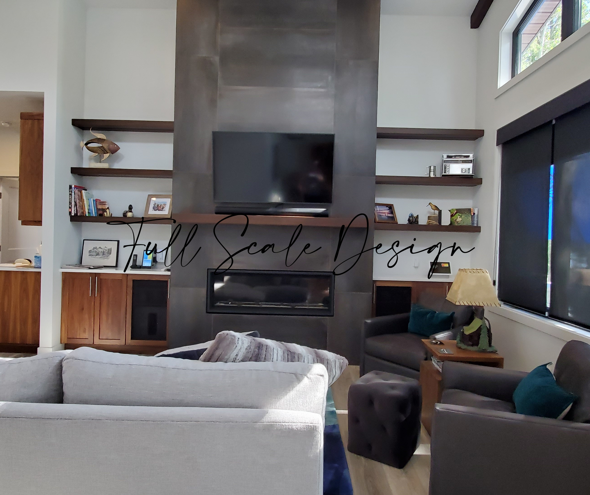 Grey and rush fireplace tile, floor to ceiling. Walnut cabinets on either side of fireplace with 3 floating shelves above. Light wall colour and light couch.