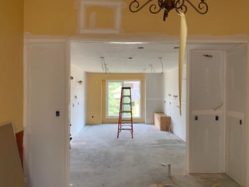 Drywall and taped walls, electrical wires and yellow walls.