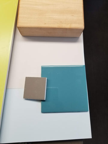 Blue, light blue, green, and grey tile samples. Maple tile sample.