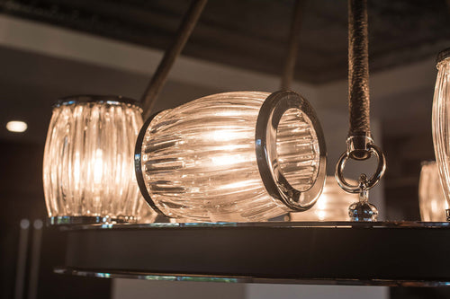 Chrome and black round chandelier with chrome rimmed, clear glass lights.