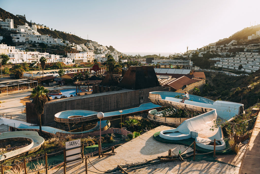 Editorial trips to warmer climes were often the only way to fill the pages of a monthly magazine during winter months. Doug McLaughlin frontside slashes in an abandoned Water Park in Gran Canaria – Photo by Chris Johnson. 