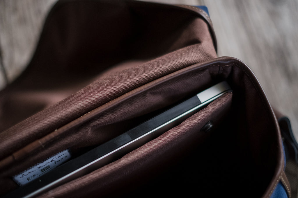 A 13" MacBook Pro in the padded laptop area at the back of the Billingham Hadley One Camera Bag.