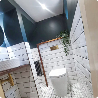 Image taken by an Unbeatable Bathrooms customer, showcasing their WC. Featuring a Back-To-Wall Toilet, Countertop Basin and Circular LED Mirror.