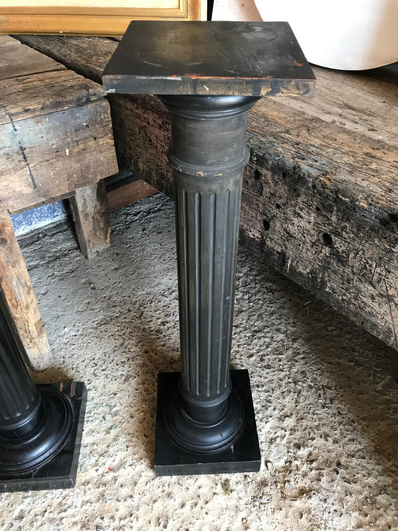 A pair of black wooden pedestal column display stands - Belle and Beast