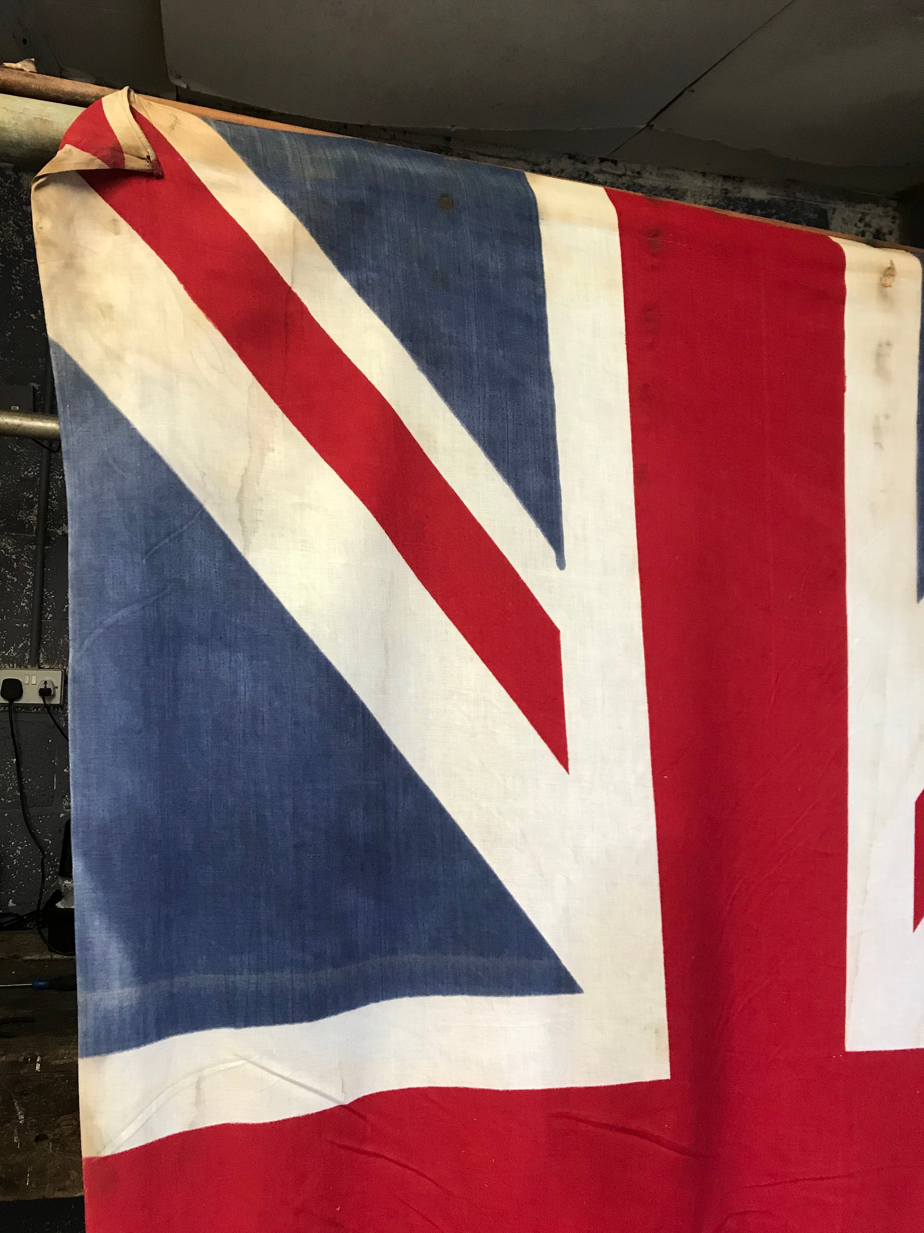 A very large Union Jack flag on a wooden pole - Belle and Beast Emporium