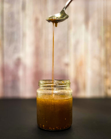 Coffee Vinaigrette slowly pouring from a spoon