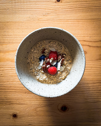 Fresh fruit and nuts on top of a bowl of overnight coffee oats