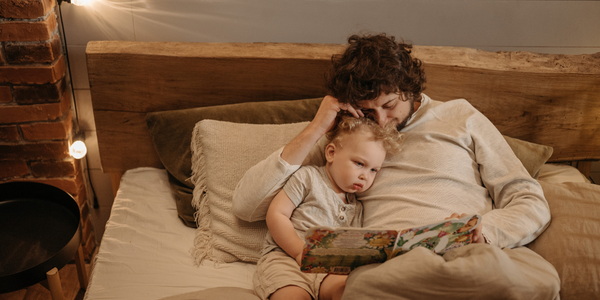 A father reads his child a bedtime story.