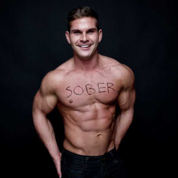 A handsome shirtless man with the word "sober" scrawled across his chest.
