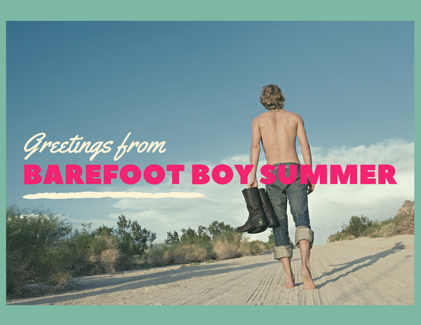 A postcard aesthetic featuring a young barefoot man walking along a sand dune carrying his boots.