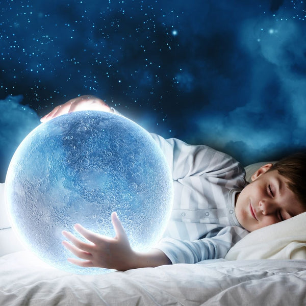A sleeping boy holds a large glowing moon.