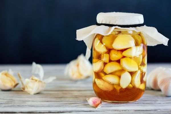 A mason jar filled with garlic-infused honey