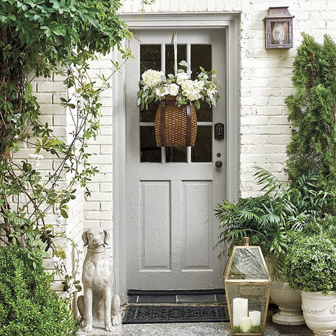 hanging flower basket on front door of house