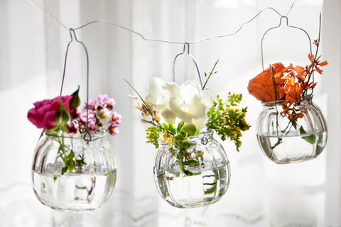 three hanging flower vases