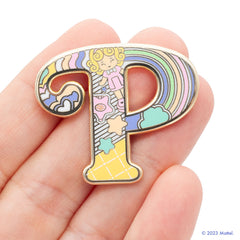 Polly Pocket "P" Pin being held by hand for size referance