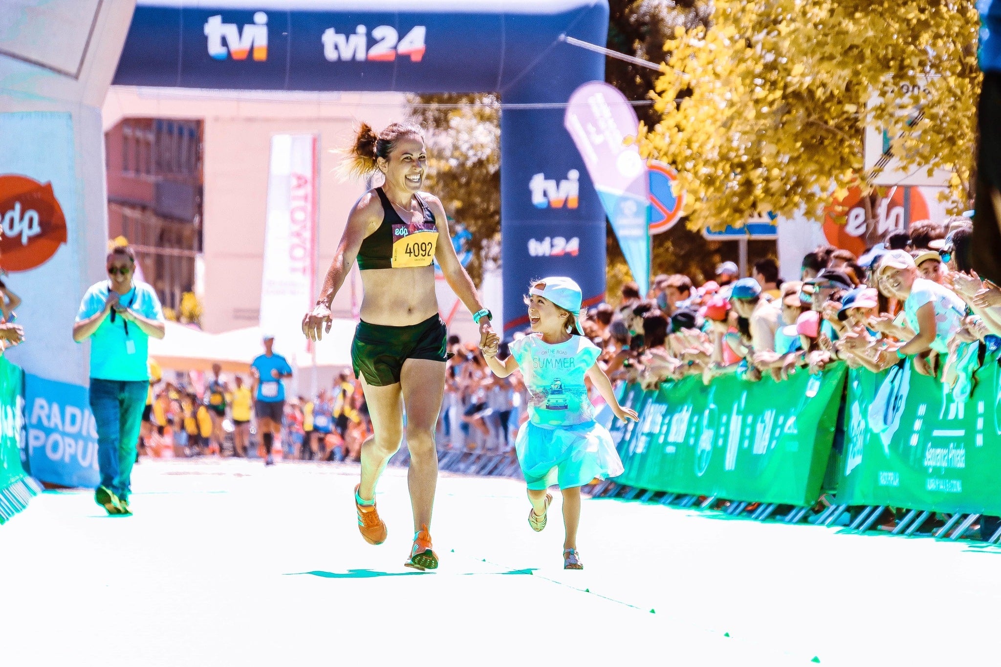 Female athlete running beside her child whose healthy diet includes collagen for kids