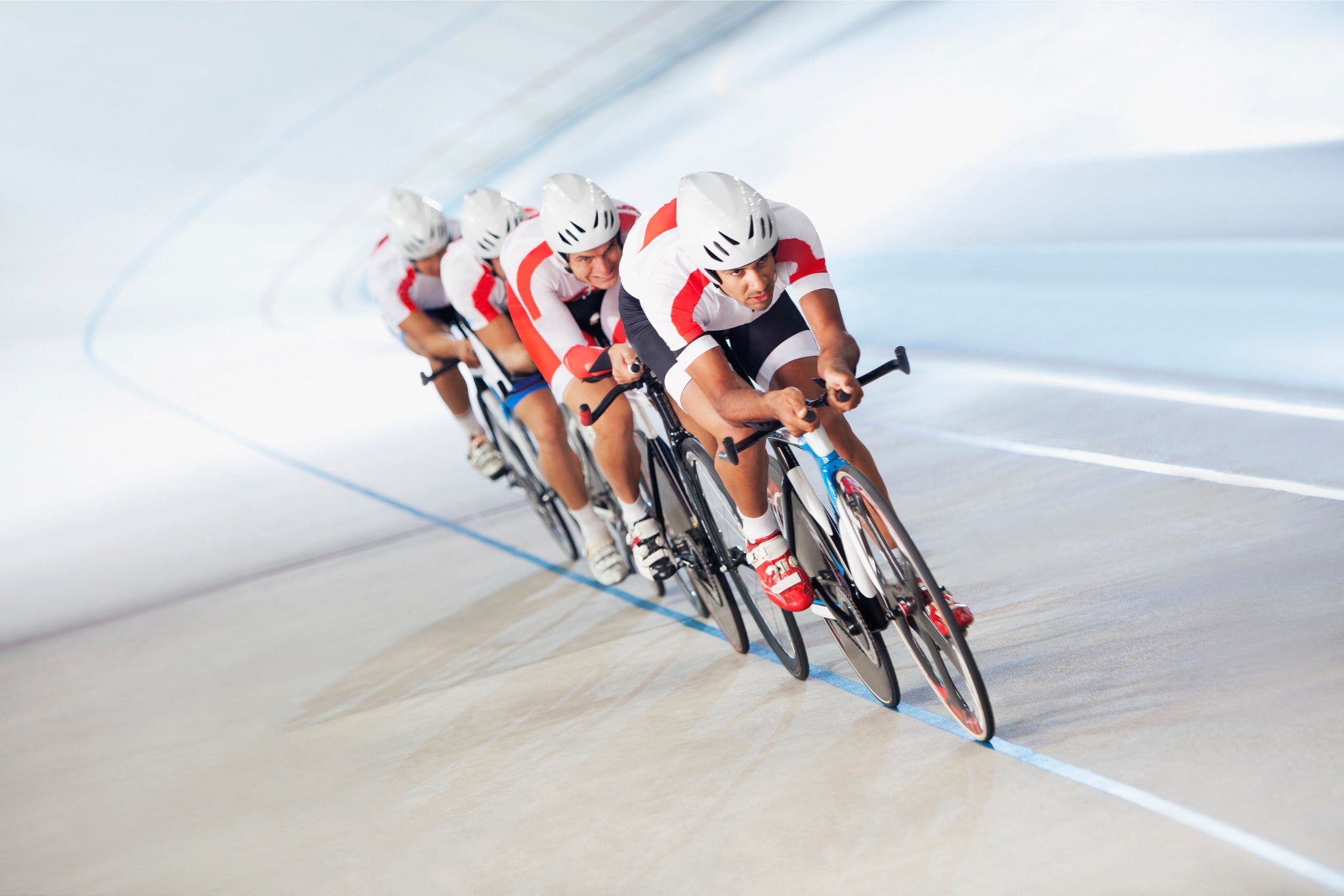 Cycling team in full gear after taking collagen protein for athletes are speeding around banked tracks during a competition