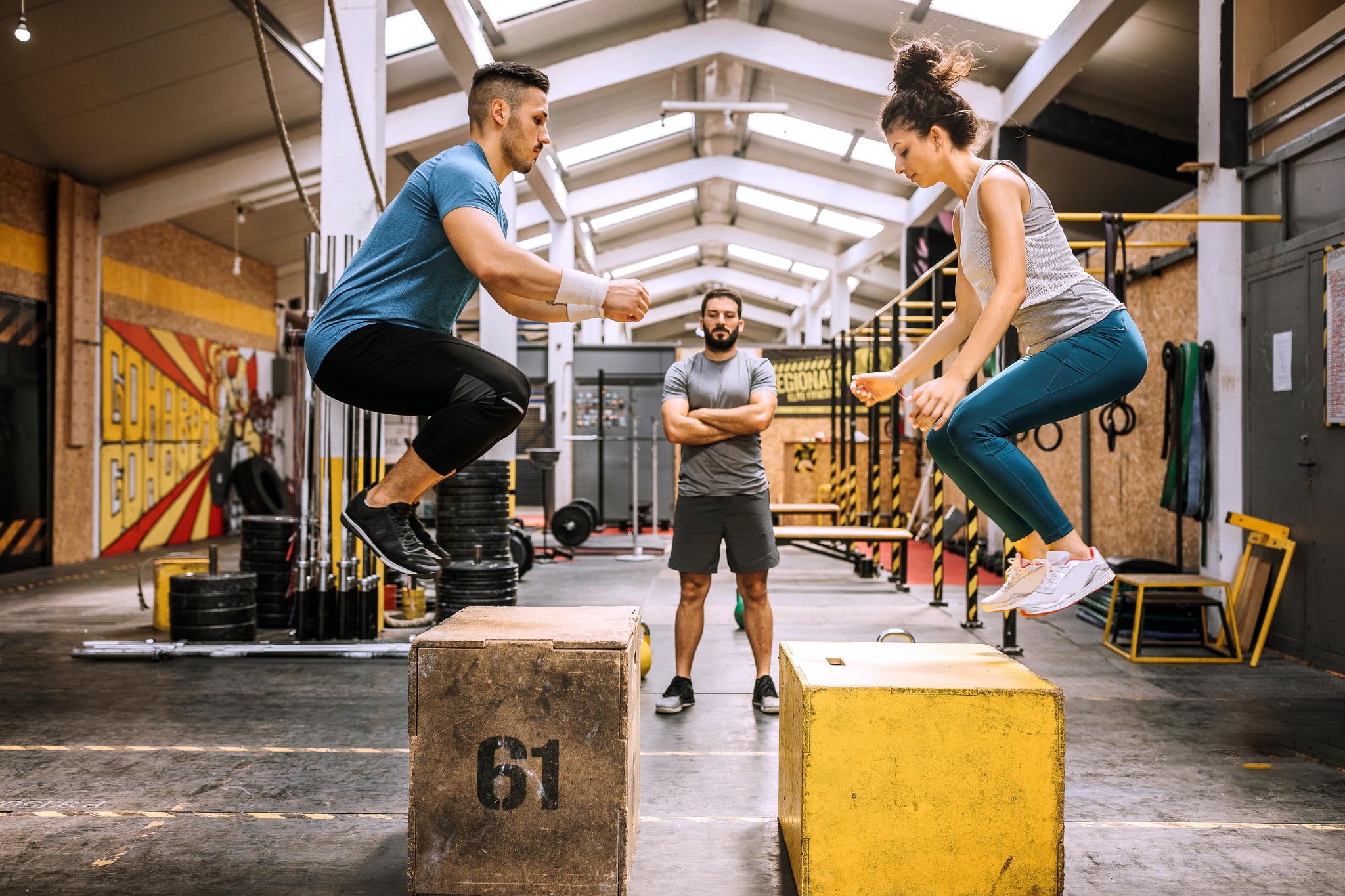 Young people doing crouch-jumping exercises on cross-training after drinking the best caffeine-free pre-workout