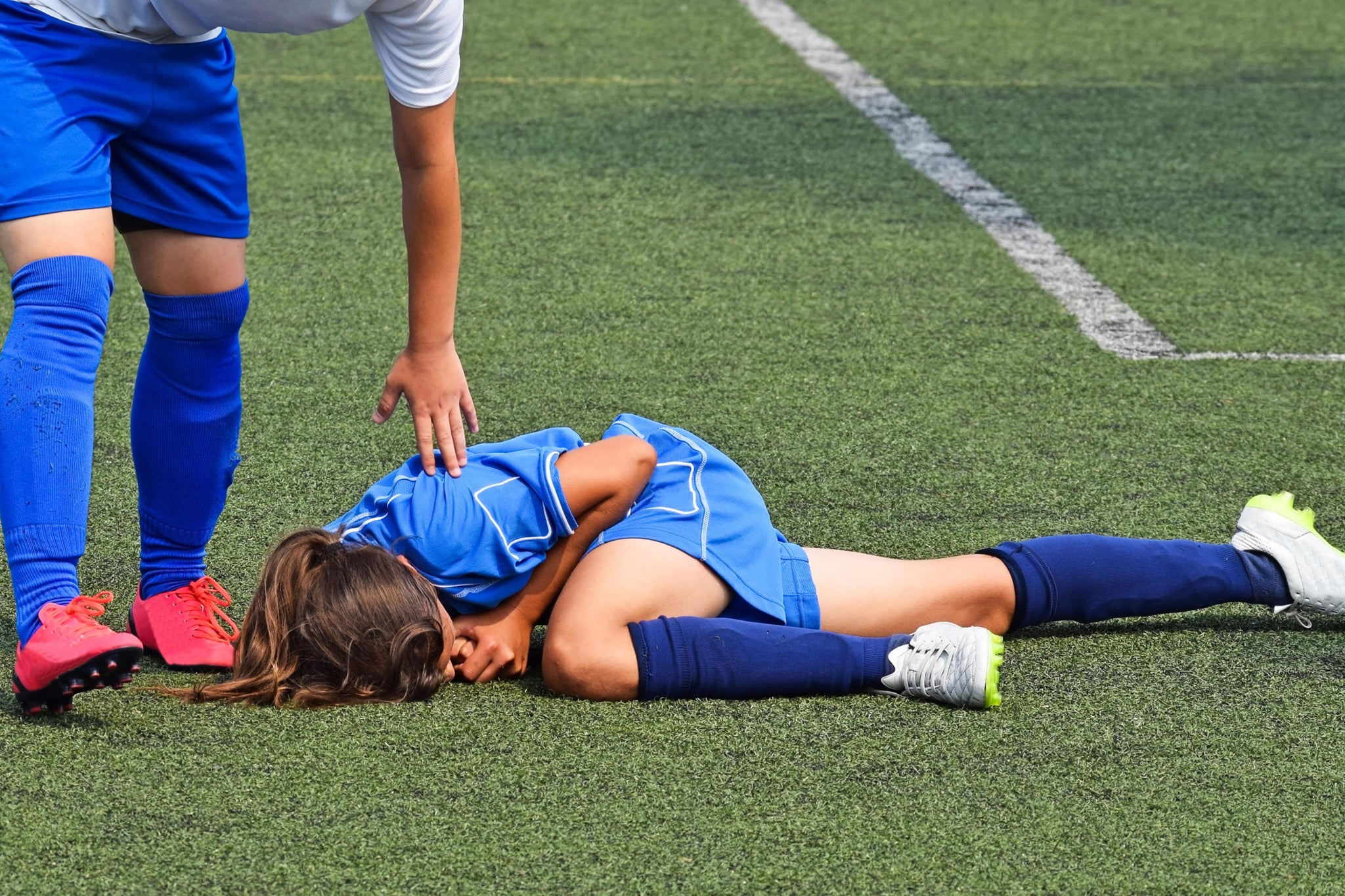 Injured female athlete during a female soccer match