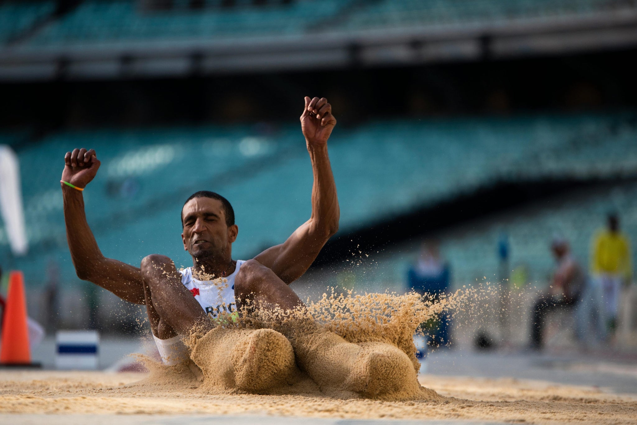 Athlete during long jump into sand