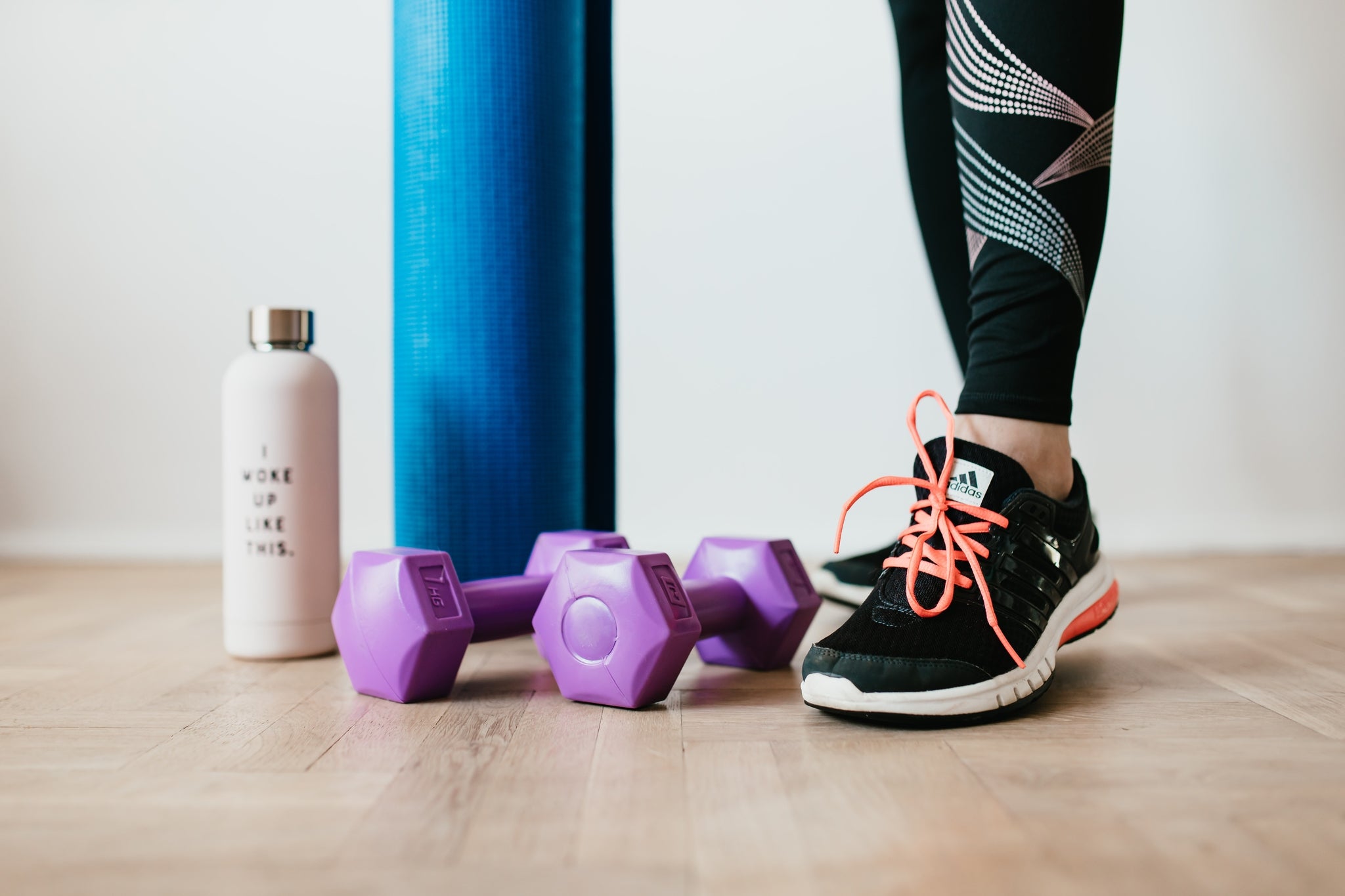 Endurance athlete standing next to her sports accessories