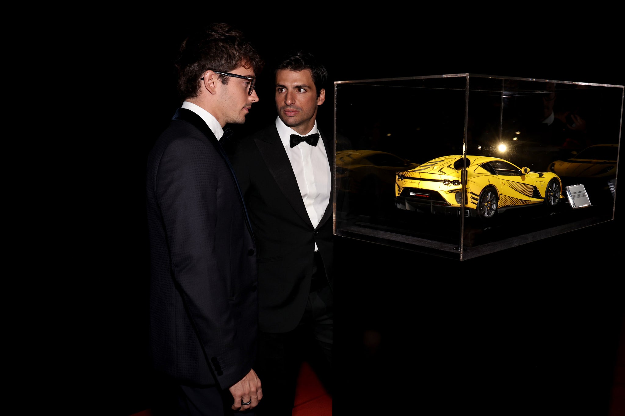 Charles Leclerc and Carlos Sainz looking at the model