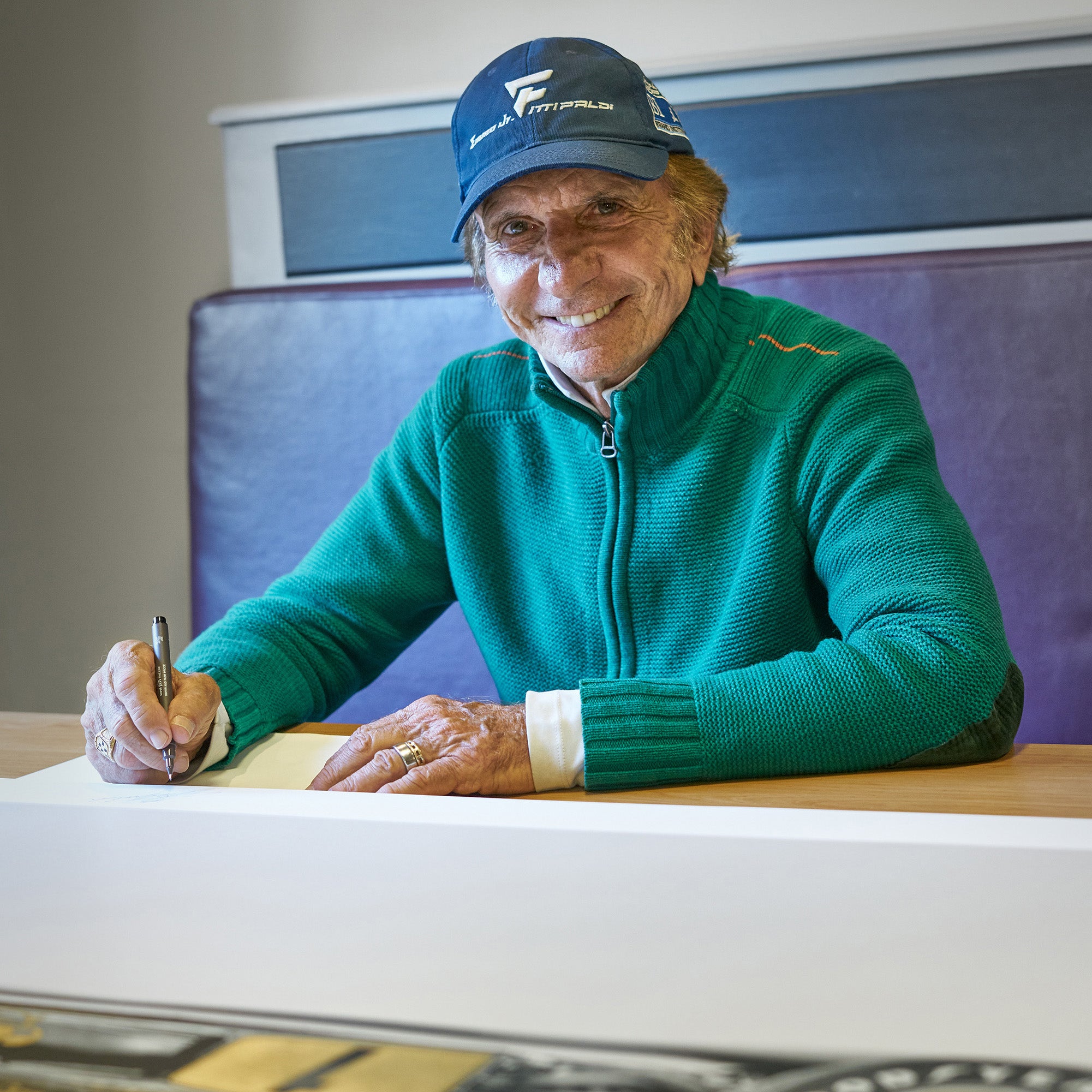 Emerson Fittipaldi - two-time Formula 1 Drivers' World Champion signing the Lotus 72 prints