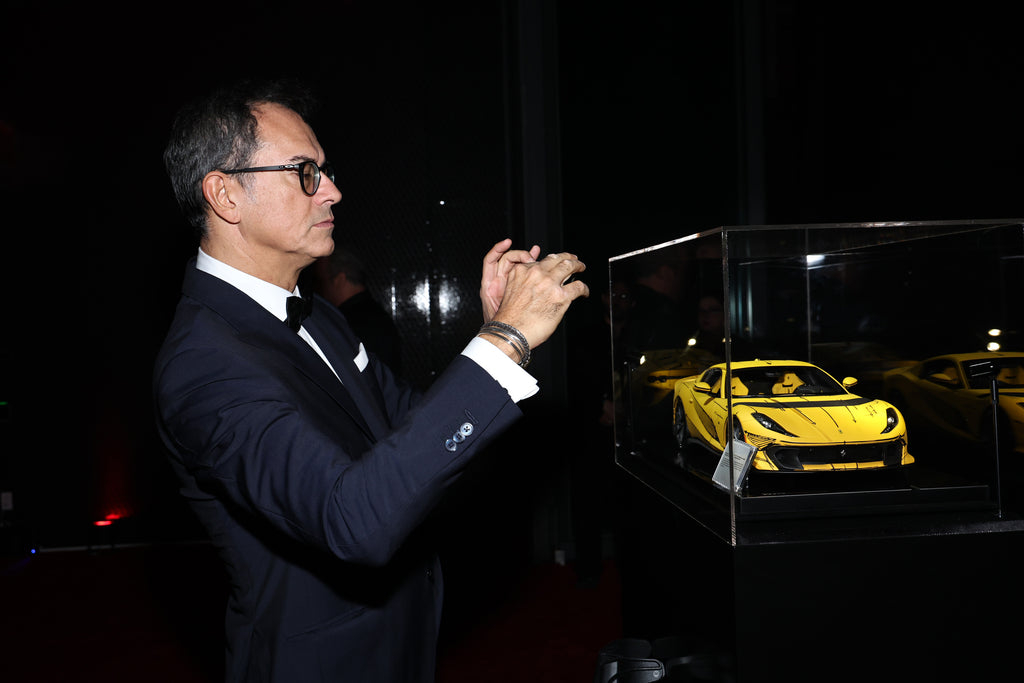 Flavio Manzoni, whose team designed the car seen admiring and photographing the model