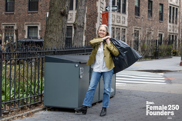 LizPicarazzi with a CITIBIN trash enclosure holding a trash bag in Brooklyn Heights Promenade