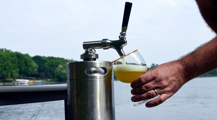 Pouring glass of Pineapple Popper from small 1-gallon keg